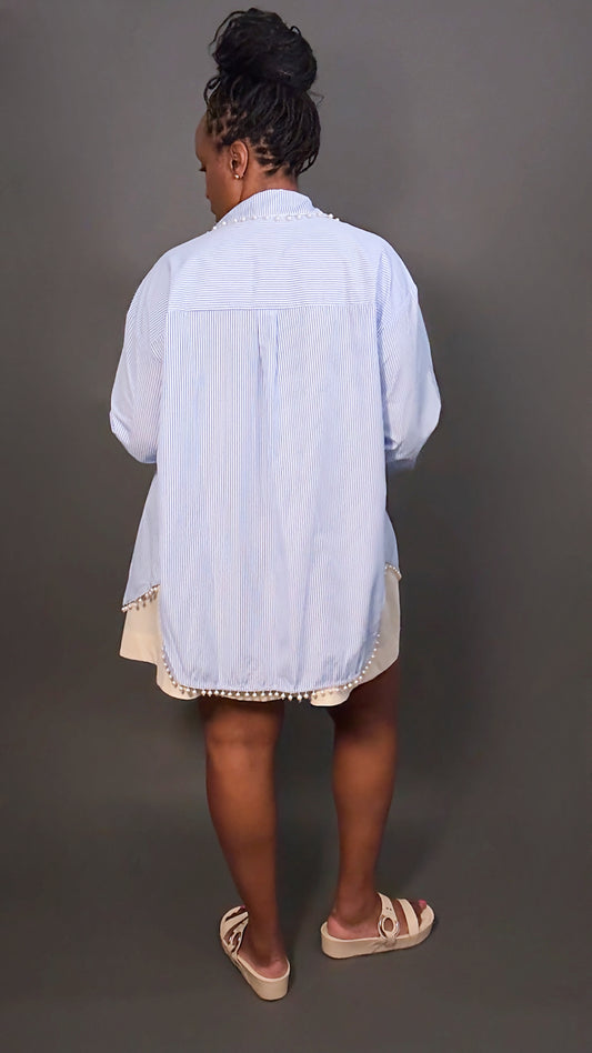 Spring fashion outfit featuring woman in faux pearl blue and white stripped button-down shirt and cream dress