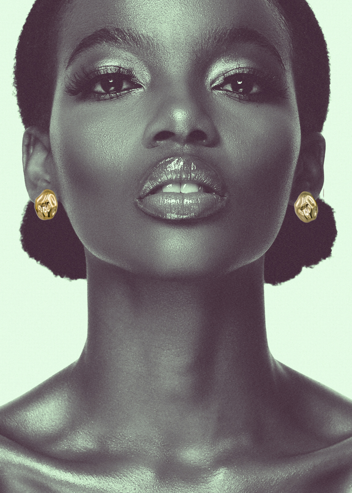 A shot of a woman's neck and head with hammered stud 18k gold plated earrings on a light background