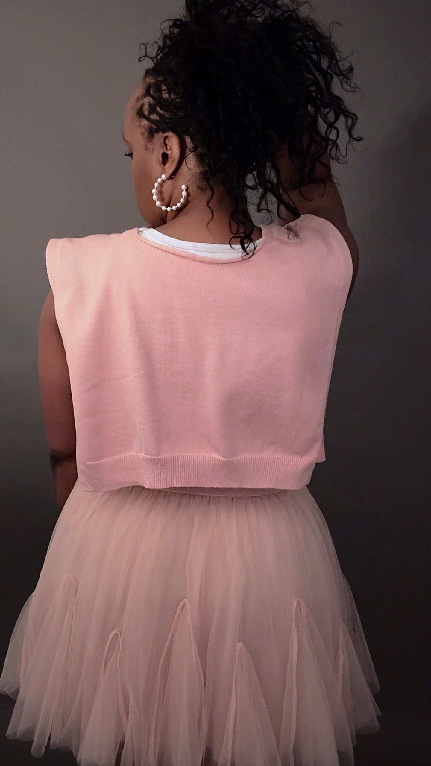 Back view of the Tara Knitted Shawl in mauve, styled for a chic, elevated casual spring outfit with flowing movement and refined texture.