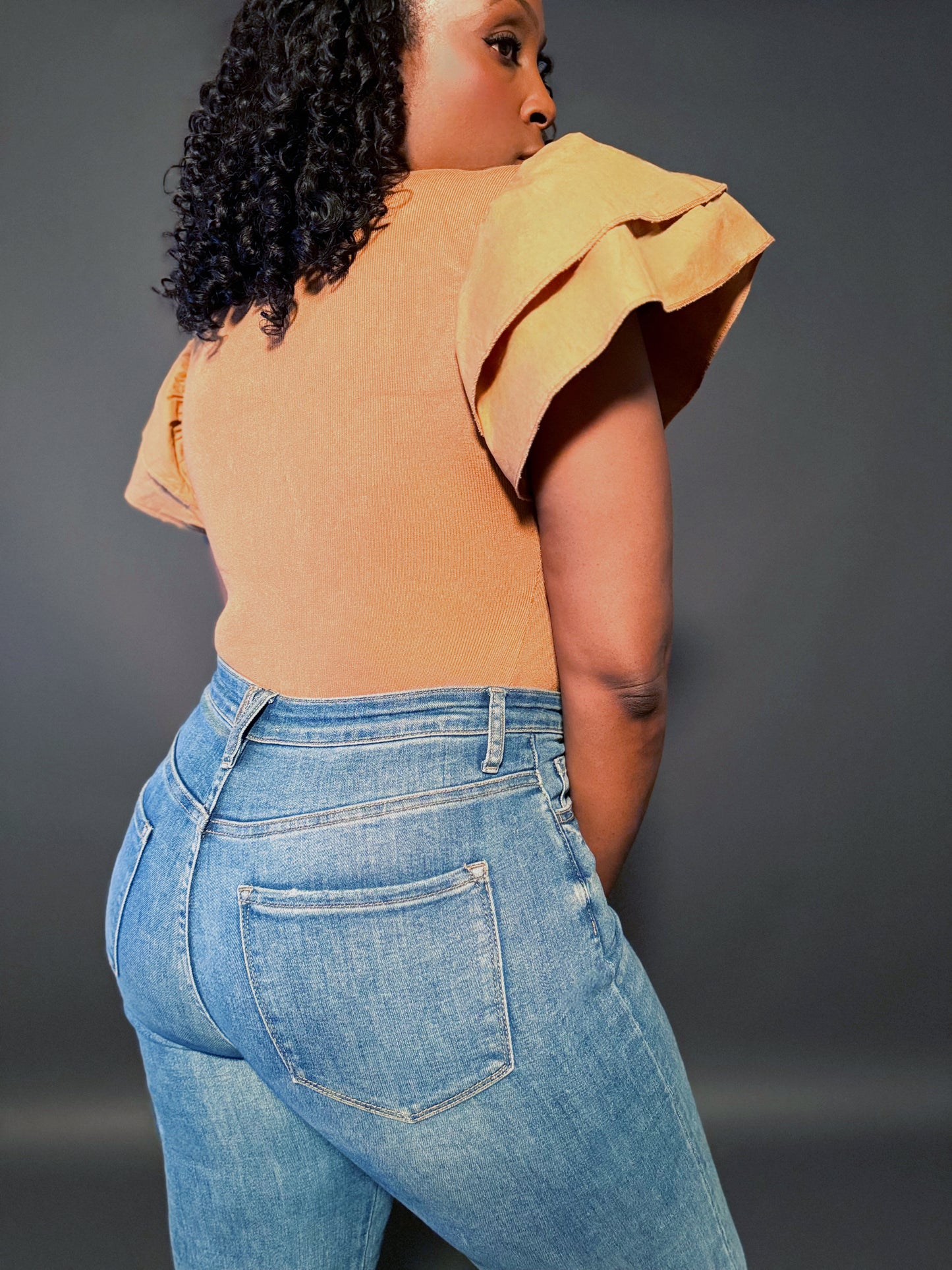 Back view of Women's Elevated Casual Ruffle Sleeve Tan Sweater Bodysuit top, showcasing the stylish ruffle sleeves and cozy knit fabric.