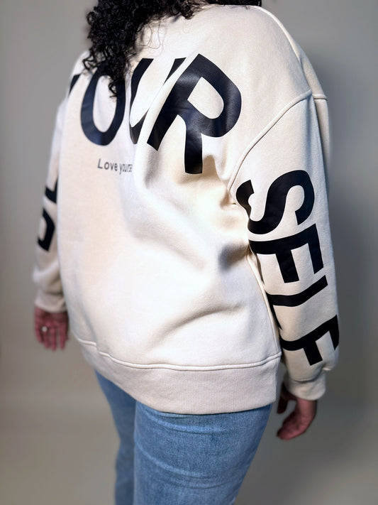 Side angle back view of Women's Elevated Casual 'Be Yourself' oversized sweatshirt, showcasing the relaxed fit, soft fabric, and bold graphic design for a stylish, laid-back look.