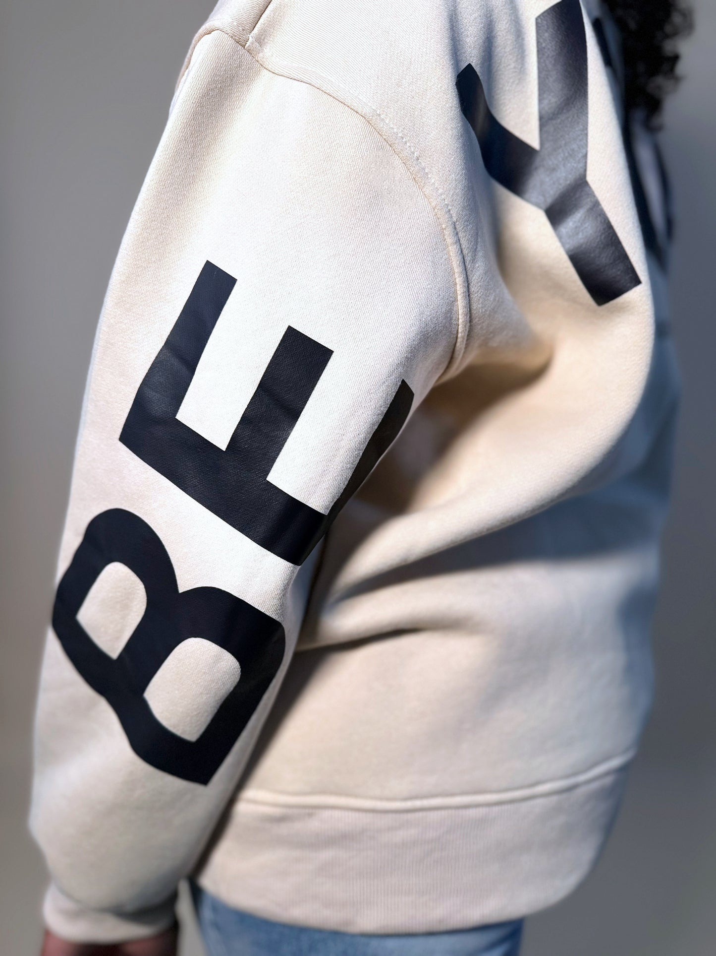 Side view of Women's Elevated Casual 'Be Yourself' oversized sweatshirt, featuring a relaxed fit, comfortable fabric, and bold graphic design for effortless style.