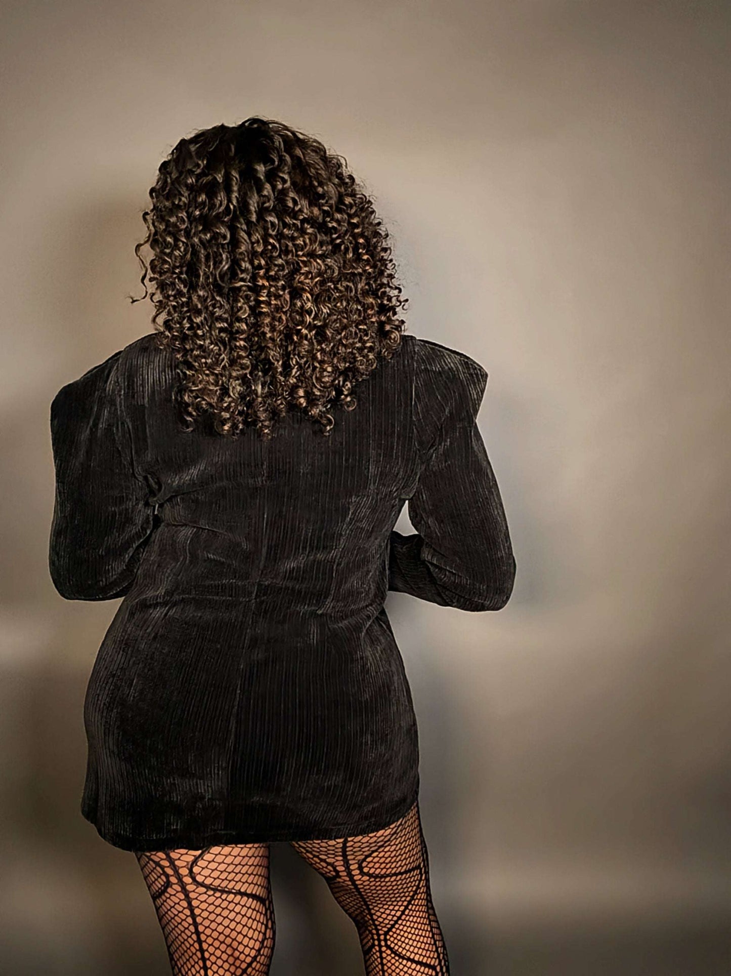 Back view of women's elevated casual black corduroy long sleeve velvet mini dress with puff sleeves , featuring a soft texture, flattering fit, and timeless style for any occasion, going out outfits or winter parties.