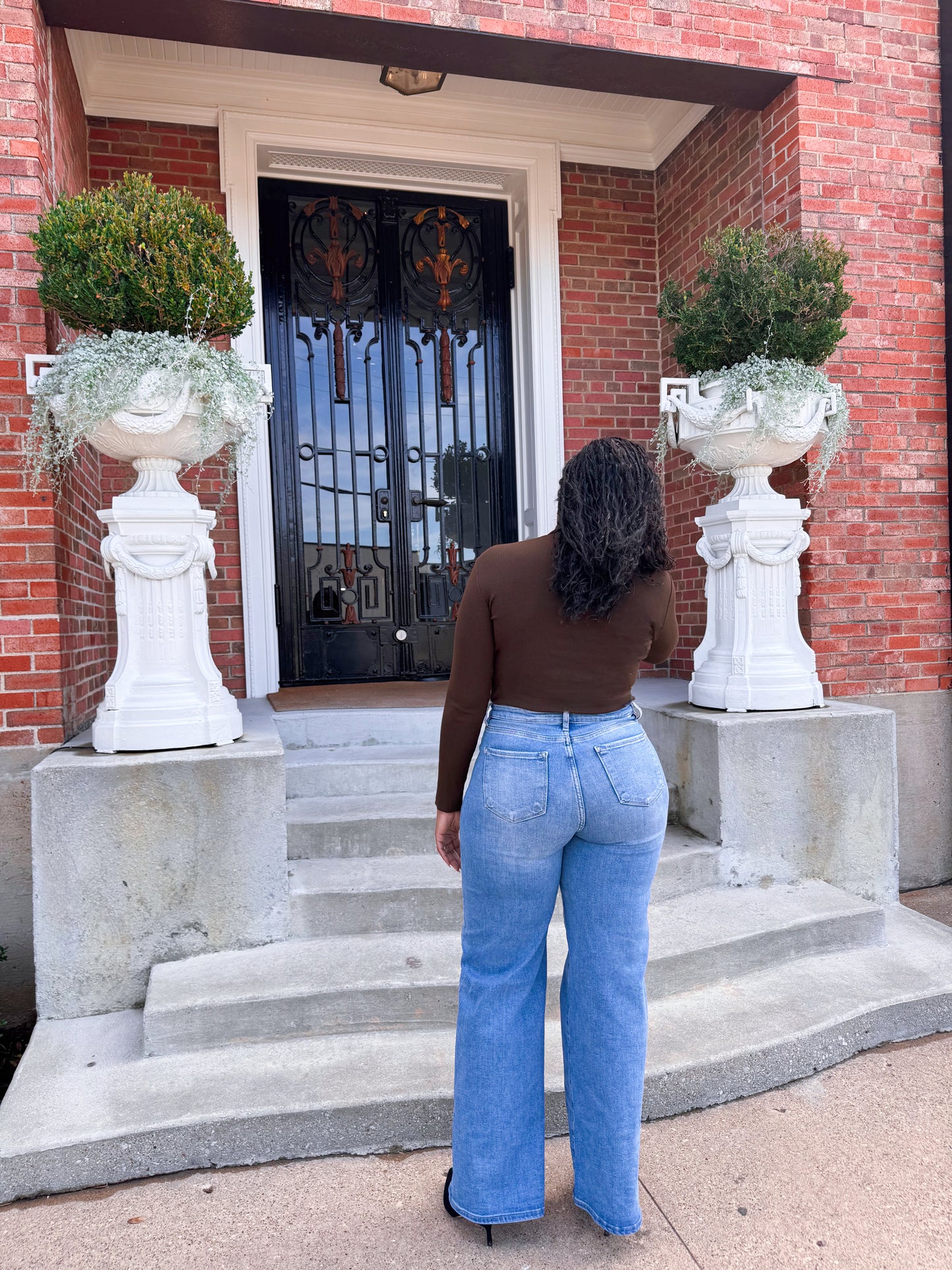 Back view of high-rise straight tummy control jeans for tall women, featuring a flattering high-waisted design in premium denim.