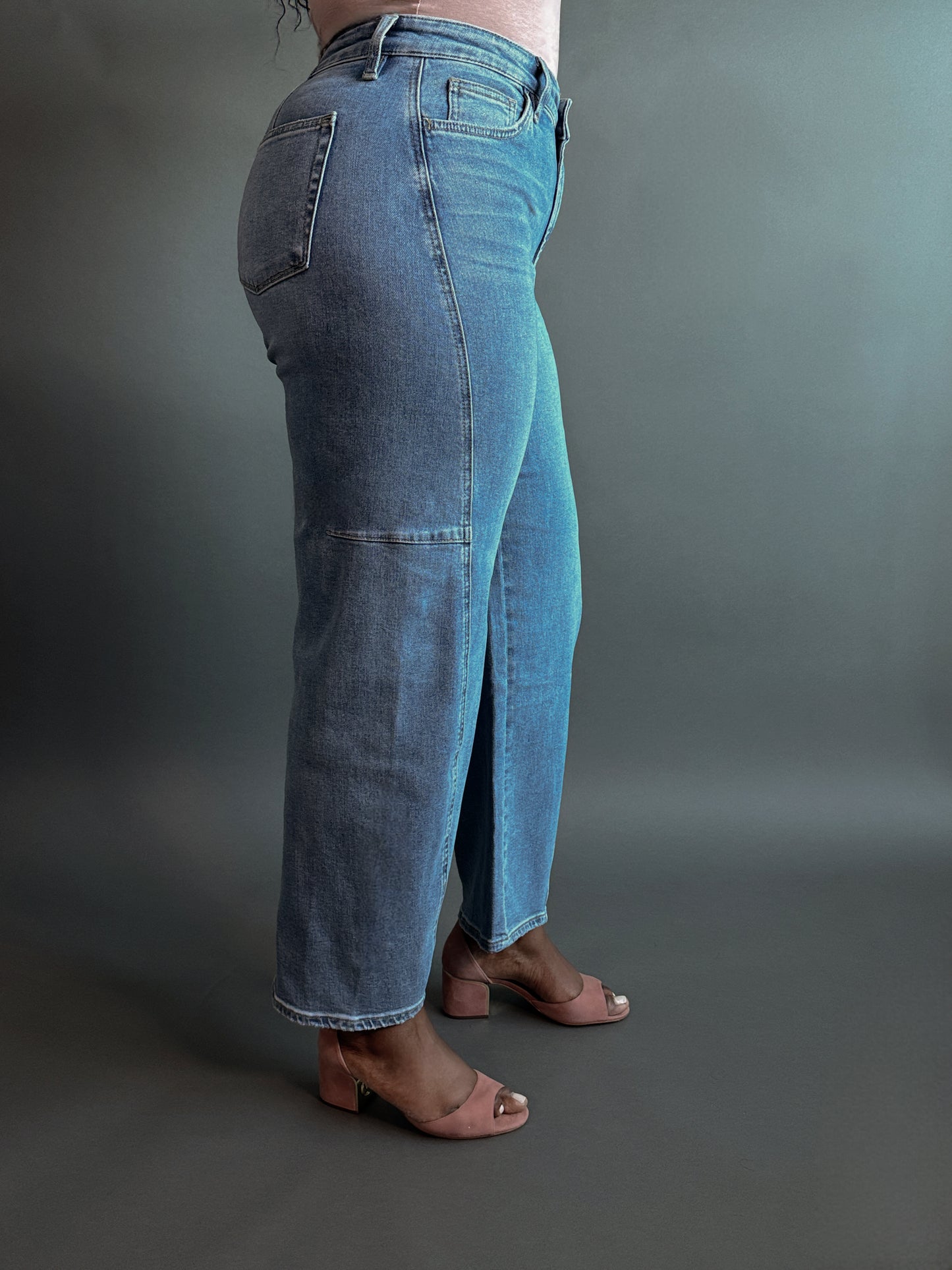 Close-up side view of women's elevated casual high-rise barrel jeans, showcasing the structured fit, high waist, and stylish barrel-leg silhouette.