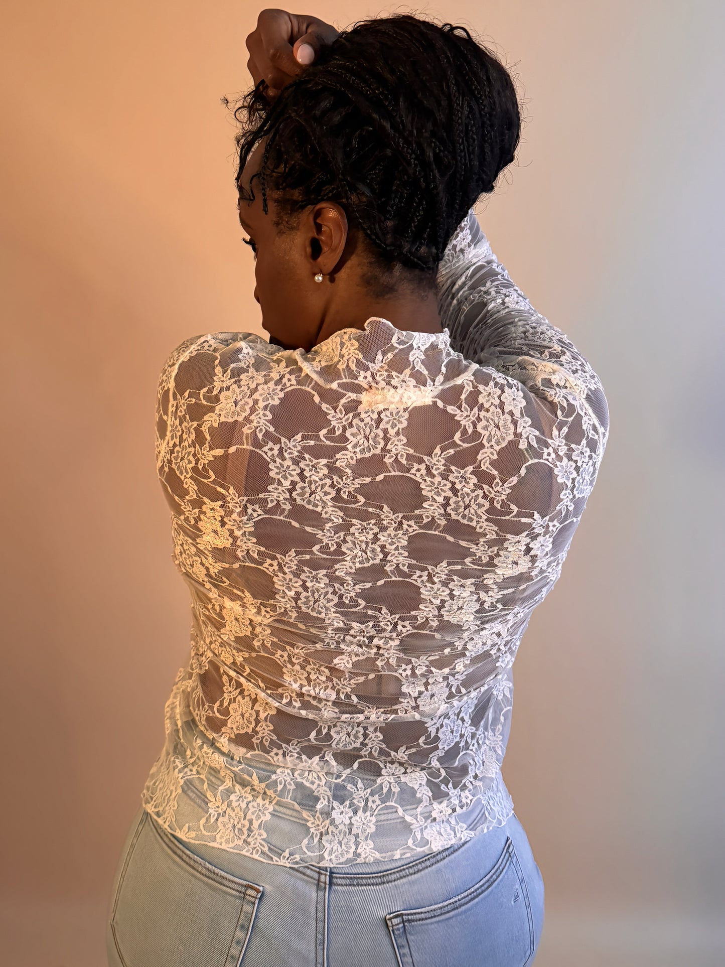 Back view of women's elevated casual white lace mock neck top, featuring a delicate lace design, long sleeves, and a flattering fit for versatile styling.