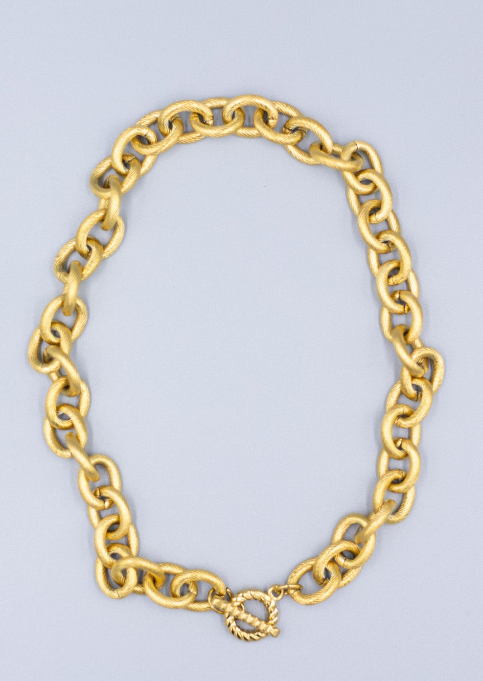 18k gold plated textured link chain necklace on a light gray background