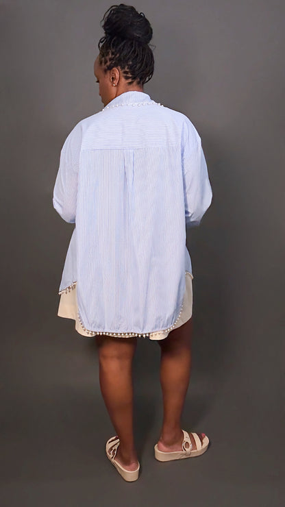 Spring fashion outfit featuring woman in faux pearl blue and white stripped button-down shirt and cream dress