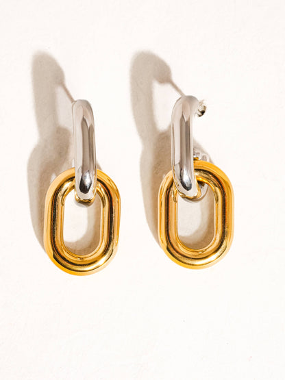 Pair of yellow and white gold chain link hoop earrings on a white background