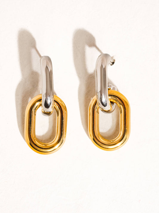Pair of yellow and white gold chain link hoop earrings on a white background