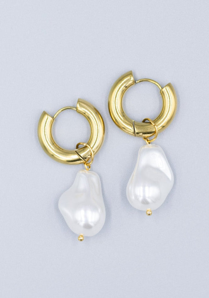 18k gold plated hoop earrings with removable dropped baroque pearls laid flat on a light gray background