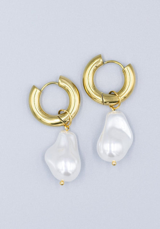 18k gold plated hoop earrings with removable dropped baroque pearls laid flat on a light gray background