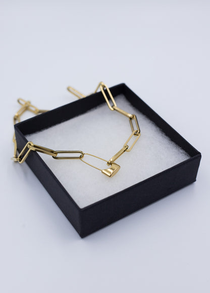 18k gold plated paperclip link necklace with a Paperclip lock closure in a black jewelry display box on a light gray background