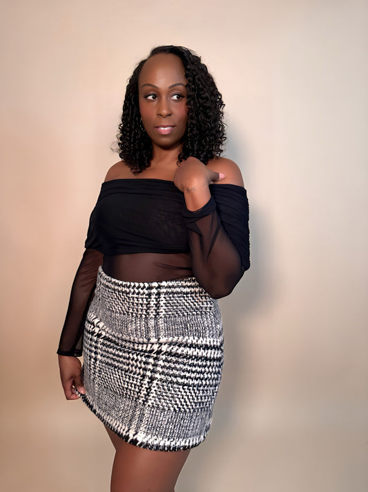 Front angled view of women's elevated casual black and white plaid mini skirt, featuring a classic pattern and comfortable, versatile design.