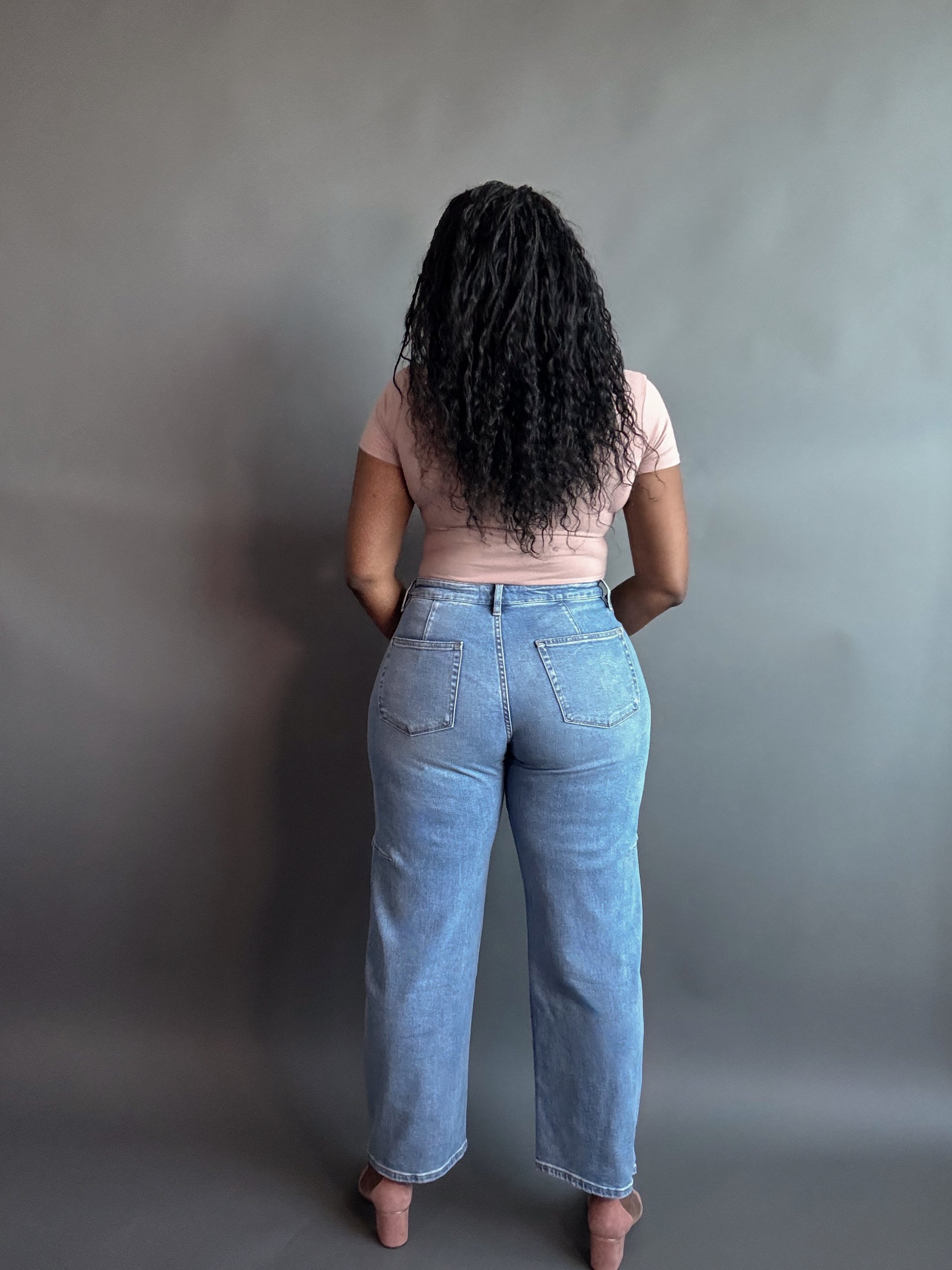 wide-leg barrel jeans styled with a bodysuit and low heels for a sleek, polished look.
