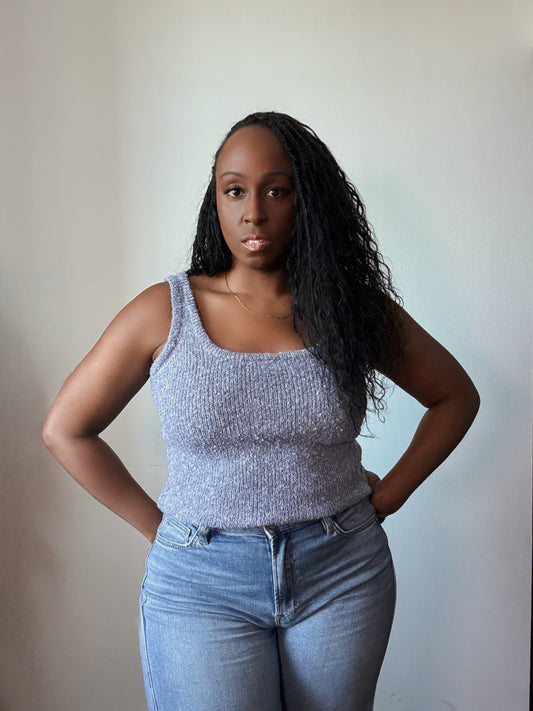 Front view of women's sleeveless solid knit top, featuring a classic design with a flattering fit, perfect for effortless styling and all-day comfort