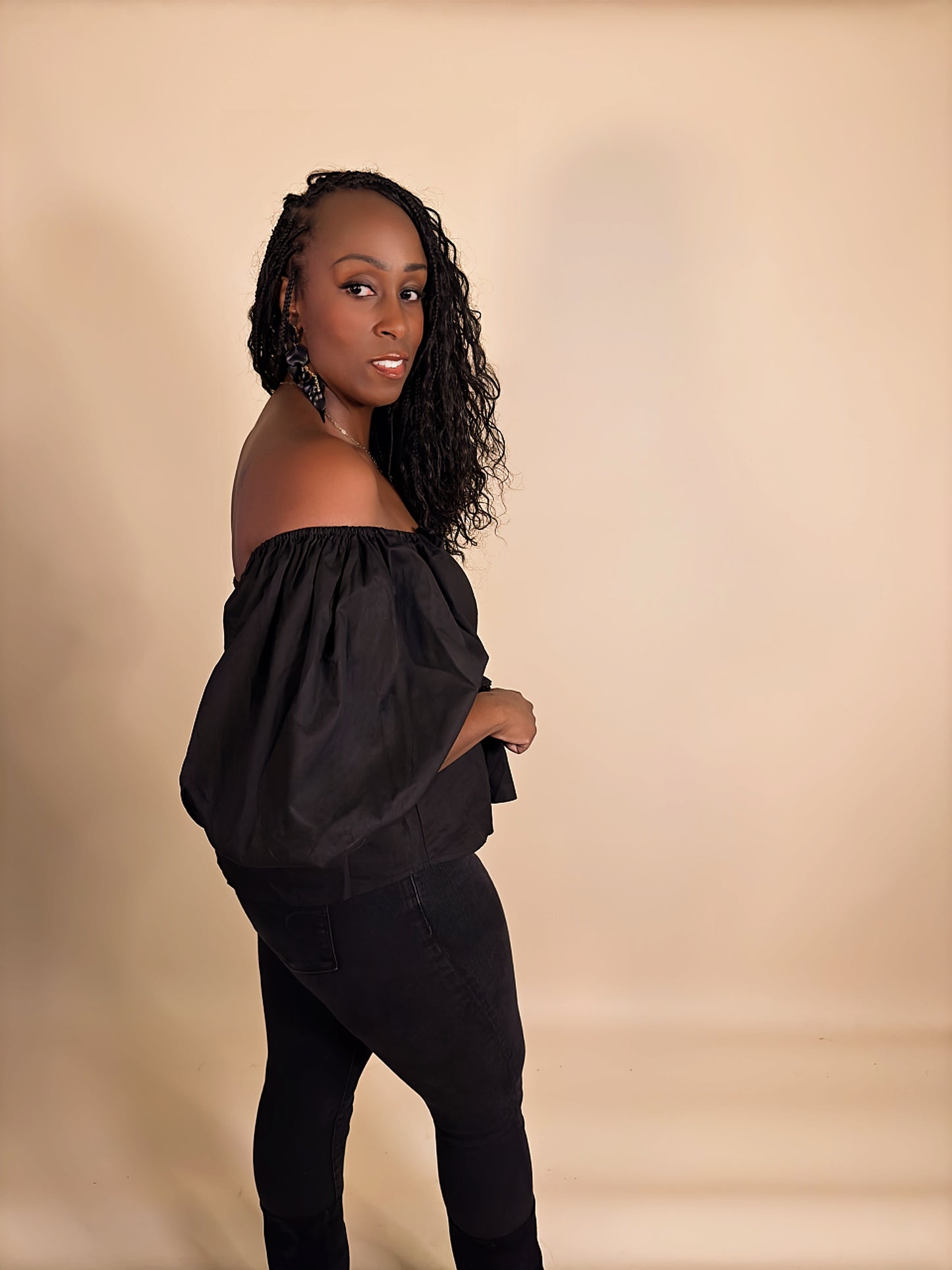 Side view of Women's Elevated Casual black Sweetheart Puff Sleeve Peplum Top, featuring delicate puff sleeves, a flattering peplum waist, and a stylish, feminine silhouette.
