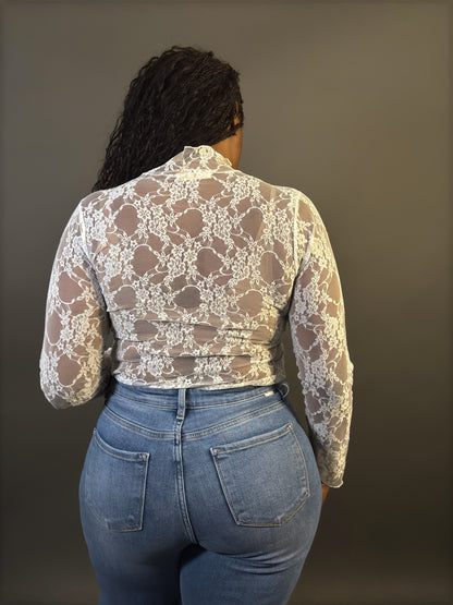 Back view of women's elevated casual white lace mock neck sheer lace top, showcasing intricate lace detailing and a stylish, fitted silhouette.