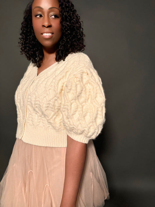 Front and side view of a short-sleeve puff-sleeve sweater, showcasing its stylish design and feminine silhouette.